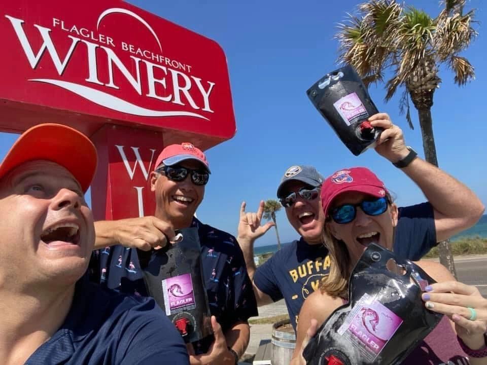 People posing at Flagler Beachfront Winery